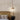 Luxe Pendant Light – Elegant Travertine Stone and Wood Design by Lumivora, a refined travertine pendant over a bed.