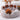 LuxLounge Dog Bed - Cuddler Lounger Paw Shaped fluffy paw lounger with small brown poodle curled up